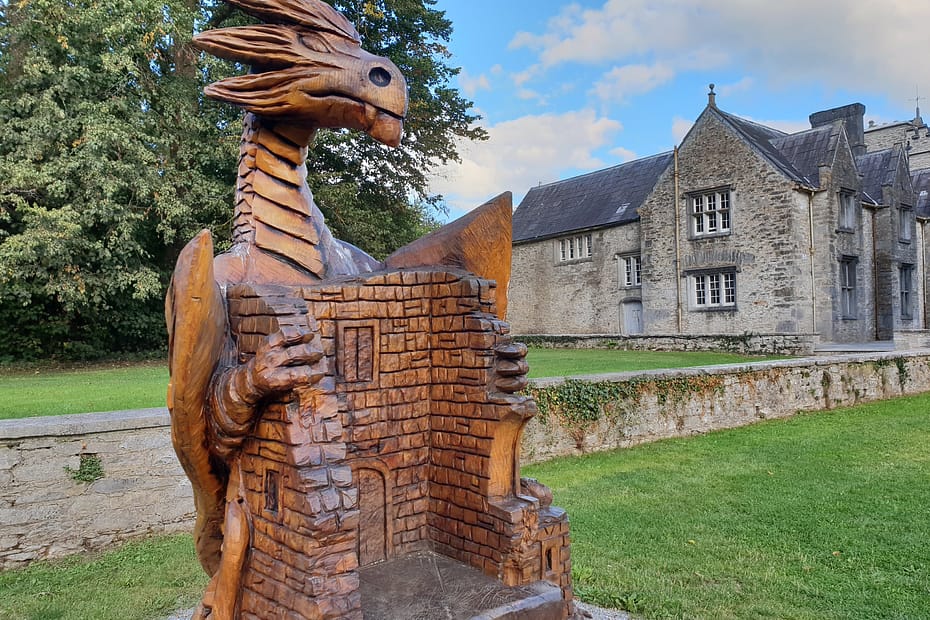 A dragon sculpture and the courtyard at Mallow Castle.